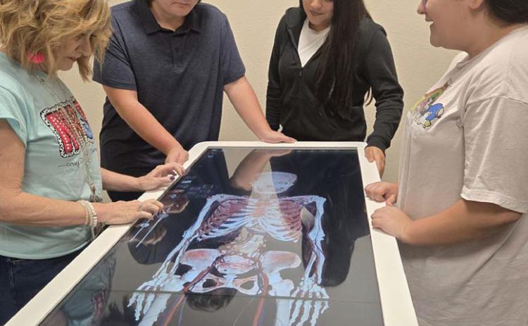 CHERI JAY-WIENECKE | DISPATCH RECORD Lometa medical teacher Valarie Nixon works with students on the Anatomage Table the district purchased with funds from a Texas Workforce Jobs and Education for Texans Grant. Pictured are, from left to right, Nixon, Tepekos Bowers, Amy Padron and Sophie Anguiano.