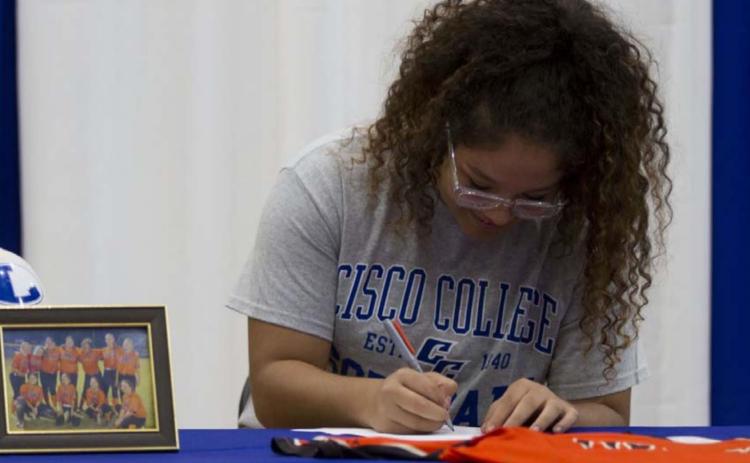 Alycia Cantu signs her letter of intent to play softball for Cisco College at the Lampasas High School gym on Wednesday. HUNTER KING | DISPATCH RECORD