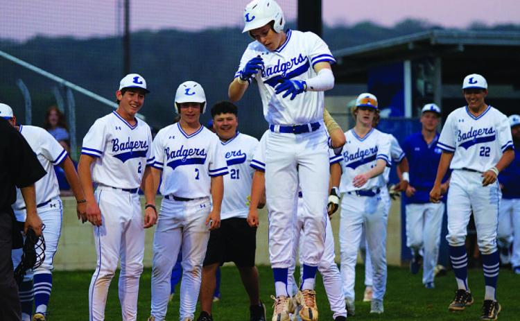 Jonas Andersen hops onto home plate after launching a two-run home run to open the scoring in last week’s game. HUNTER KING | DISPATCH RECORD