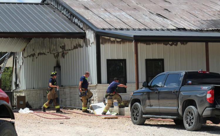 Crews remained on the scene of a house fire Wednesday on County Road 3064 after the flames were extinguished. The homeowner was in the house at the time of the fire and escaped without injuries. Joycesarah McCabe | Dispatch Record