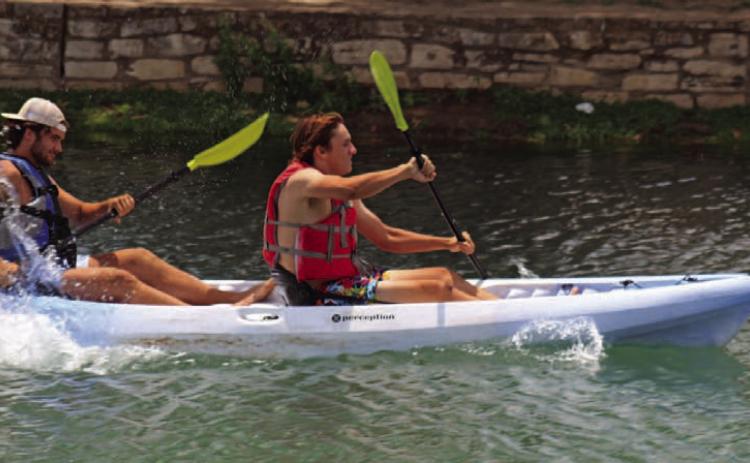Tate Rainwater and Aden Rascoe paddle like experts in the 2023 Spring Ho Adult Tandem Kayak Race, where they took home the win. AJOYCESARAH MCCABE | DISPATCH RECORD