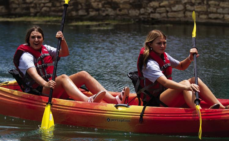 Sagen Plouff and Pacey Underwood paddle down the creek during the youth tandem race last Saturday. HUNTER KING | DISPATCH RECORD