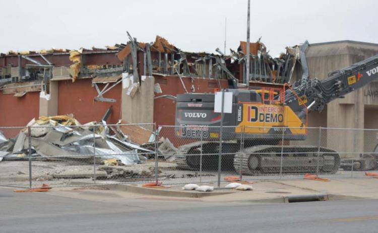 The exterior of the old county jail was broken down by Alamo 1 construction cranes on Wednesday afternoon. Additional abestos was discovered in the building roof during last week’s abatement, according to an Alamo 1 employee. MONIQUE BRAND | DISPATCH RECORD