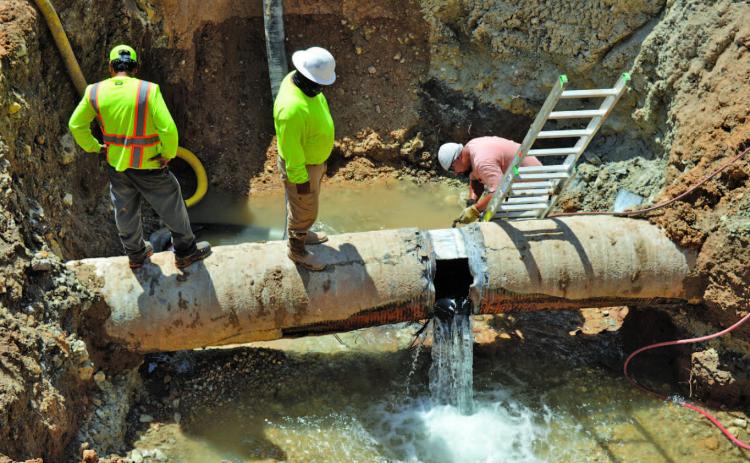 Workers empty the Kempner Water Supply Corp.’s main transmission line to Lampasas in July after a major leak occurred. ERICK MITCHELL | DISPATCH RECORD