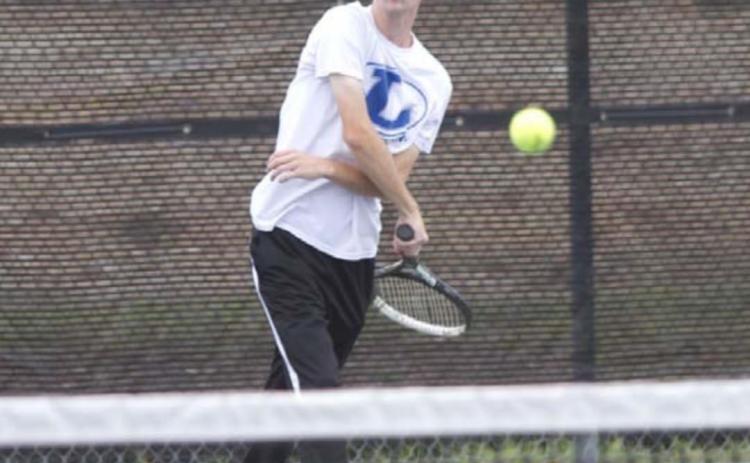 Travis Calk finishes on a serve during the win over Glen Rose. HUNTER KING | DISPATCH RECORD