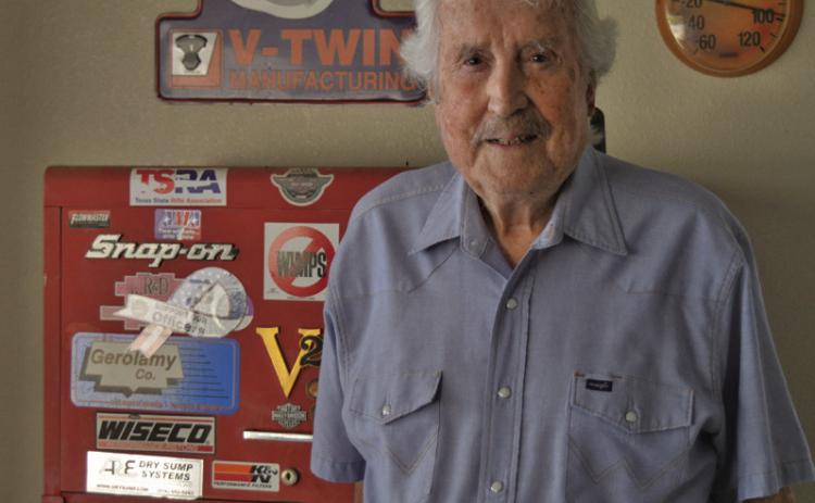 Former motorcycle drag racer Mel Disharoon poses for a photo in front of a toolbox in his garage. Despite being 89 years old, Dishroon stopped riding bikes just three months ago after seven decades on the saddle. ERICK MITCHELL | DISPATCH RECORD