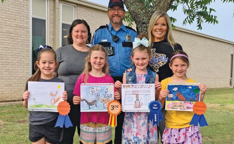 Front row, left to right, are Kylee Kruppa, Ava Latham, Kylee Davis and Evie de Klerk. These students were recognized by the Texas Department of Health and Human Services for their artwork in the department’s Rabies Awareness and Prevention Poster Contest. Back row are Kasey Schwartzer, supervisor of the local animal shelter; animal control officer Joseph Schwartzer; and Kline Whitis Principal Leanne Bobo. erick mitchell | dispatch record