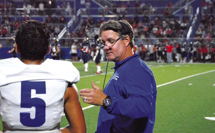HUNTER KING | DISPATCH RECORD Head coach Troy Rogers coaches his quarterback David Flores in the second half of the East View game last Friday.