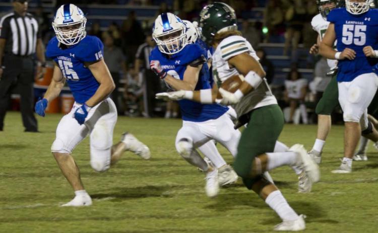 Case Brister, left, and Carson Bekker pursue a Canyon Lake ball carrier during last week’s game. HUNTER KING | DISPATCH RECORD