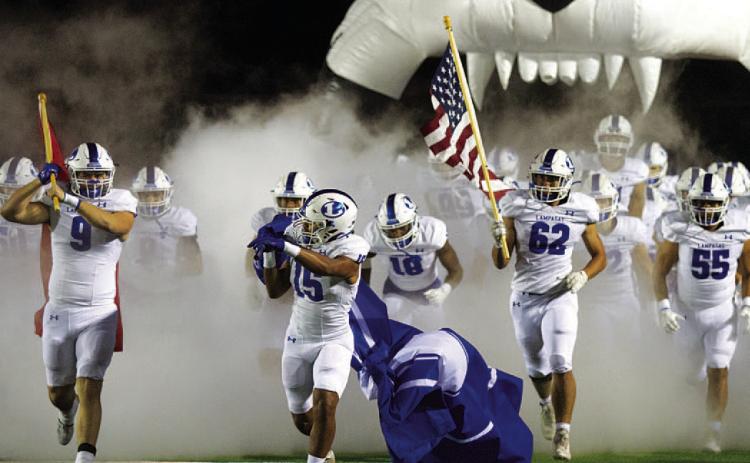 HUNTER KING | DISPATCH RECORD Brady Renfrew (9), Dailan Fagan (15) and Nick Torrez (62) lead the Badgers onto the field.