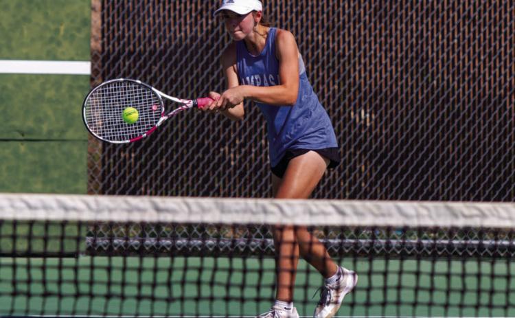 Lampasas freshman Eva Lowe returns a volley in the Badgers’ final doubles win Oct. 6, helping claim the team’s 15-4 victory against Seguin Navarro. ANA SOFIA MEYER | DISPATCH RECORD