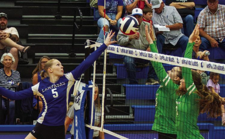 Lampasas junior outside hitter Mattie McBeth tips the volleyball over the net for a kill. PHOTO BY ANA SOFIA MEYER | DISPATCH RECORD