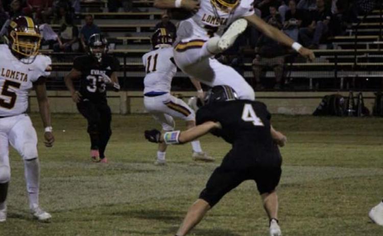 Alonso Caso hurdles over an Evant defender during the Hornets’ dominant win last week. JESSICA MALDONADO | DISPATCH RECORD