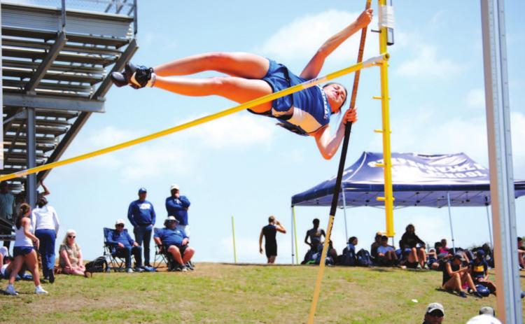 Peyton Tatum vaults over the bar in her first round and on her way to a fourth-place finish at the district meet. HUNTER KING | DISPATCH RECORD