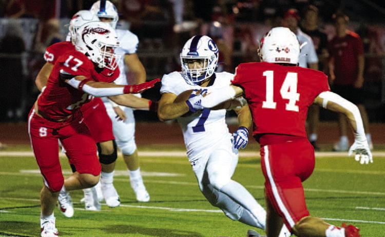 HUNTER KING | DISPATCH RECORD Daemian Rivas splits two Salado defenders. The senior ran for 144 yards last Friday night.