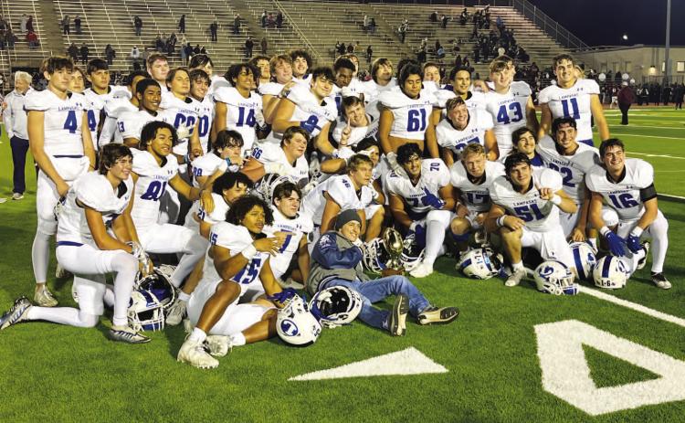 HUNTER KING | DISPATCH RECORD The Badgers pose with their bi-district trophy after last week’s win over Uvalde.