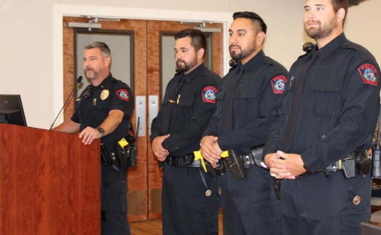 Patrol Lt. Chuck Montgomery presents new police officers Brandon English, John Reza and Jameson Varnado, left to right, at a Lampasas City Council meeting on Monday. COURTESY PHOTO