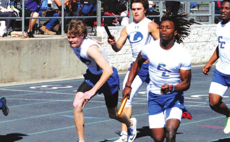 Aden Rascoe passes the baton to Nate Borchardt during the Badgers’ 4x200 meter relay race last Thursday. HUNTER KING | DISPATCH RECORD