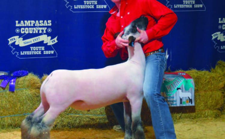 Cayhil Isom claimed grand champion honors with his heavyweight medium wool lamb. ERICK MITCHELL | DISPATCH RECORD