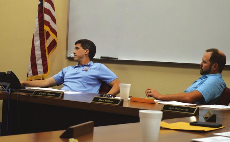 ERICK MITCHELL | DISPATCH RECORD Lampasas ISD Superintendent Dr. Chane Rascoe, at left, and Board of Trustees President Ryan Shahan listen to a presentation on facility needs and the financing options that could be available to address those.