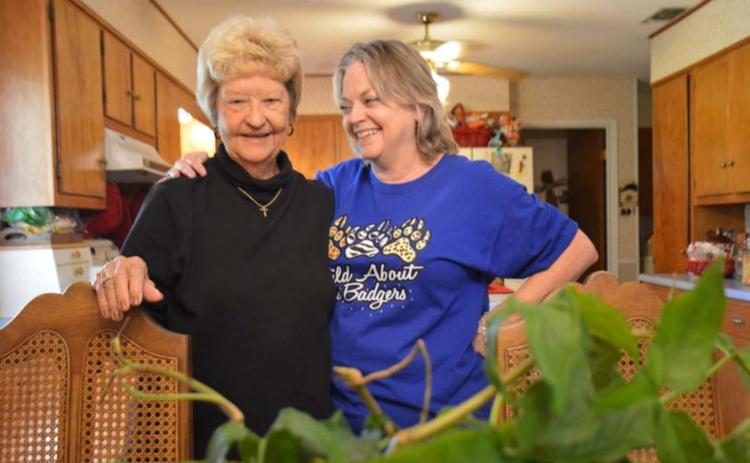 Treva Clark and daughter, Melanie Brooks, share family stories with the ivy plant that has been in the family for decades. MONIQUE BRAND | DISPATCH RECORD