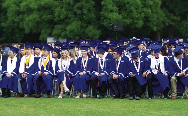 HUNTER KING | DISPATCH RECORD Lampasas High School seniors wait to receive their diplomas after being introduced at last week’s ceremony.