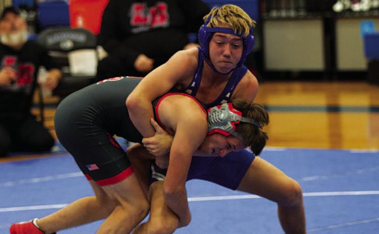 HUNTER KING | DISPATCH RECORD Laeton Kepler grapples with his opponent during the wrestling meet Wednesday night.