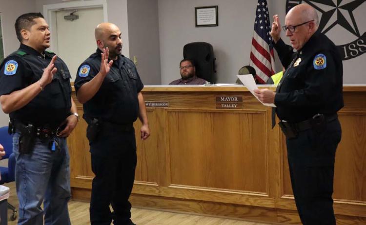 Lometa Police Chief Ronnie Strain swears in the police department’s newest officers. Jose Velazquez, at left, and Morrad Yasin, center, are now patrolling Lometa’s streets and serving the residents. CHERI JAY-WIENECKE | DISPATCH RECORD