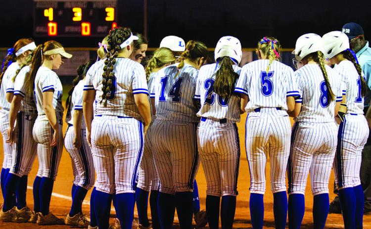 Members of the softball team surround home plate to celebrate a Madison Magilke home run against Marble Falls. HUNTER KING | DISPATCH RECORD