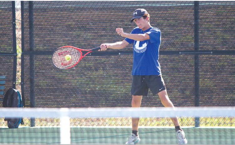 Brock Messinger swings through a forehand shot during Tuesday’s win over Glen Rose. The Badgers took every match. HUNTER KING | DISPATCH RECORD