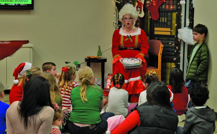 Mrs. Claus spent time reading books to children at the Lampasas Public Library. ERICK MITCHELL | DISPATCH RECORD