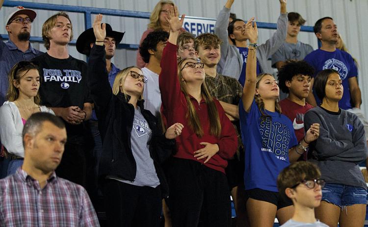 Students praise the Lord and sing along to worship music to close out the Fields of Faith celebration. The event takes place annually in October at Badger Stadium. hunter king | Ldispatch record