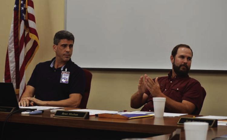Lampasas Independent School District Superintendent Dr. Chane Rascoe (left) and Board President Ryan Shahan discuss the future middle school campus’ square footage during Monday’s meeting. ERICK MITCHELL | DISPATCH RECORD