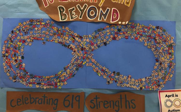 All 619 Taylor Creek Elementary School students played a part in this infinity symbol that recognizes April as Autism Awareness month. COURTESY PHOTO