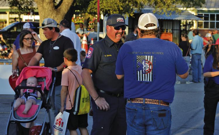 Lampasas Fire Chief Tim Davis, right, speaks with Lampasas High School EMT teacher Steve Haviland during last year’s event. Plenty of local and state law enforcment agencies will be at Tuesday’s National Night out event in the Lampasas H-E-B parking lot. FILE PHOTO