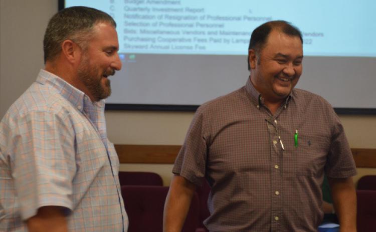Harvey Stinnett, right, and Jeff Rutland share a laugh after a swearing-in ceremony during Monday’s regular meeting of the school board. Stinnett is new to the board, and Rutland was uncontested for re-election to his trustee position.MONIQUE BRAND | DISPATCH RECORD