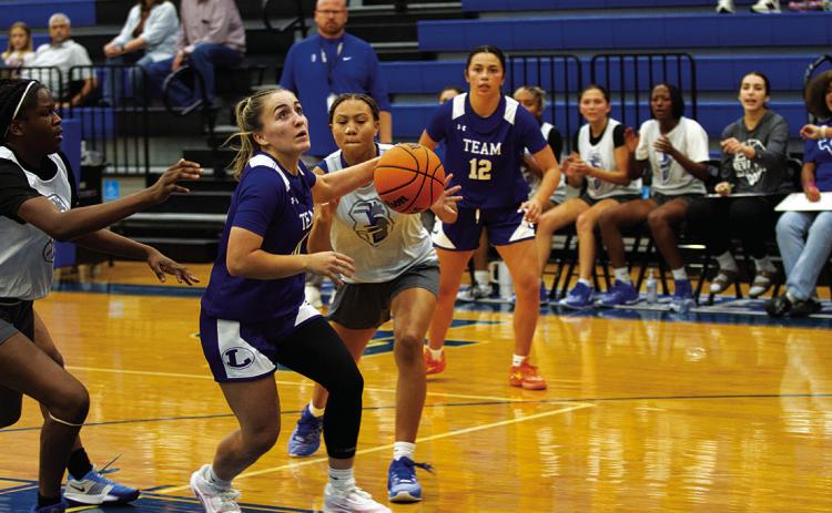 Payton Crawford navigates through traffic to score two points. HUNTER KING | DISPATCH RECORD