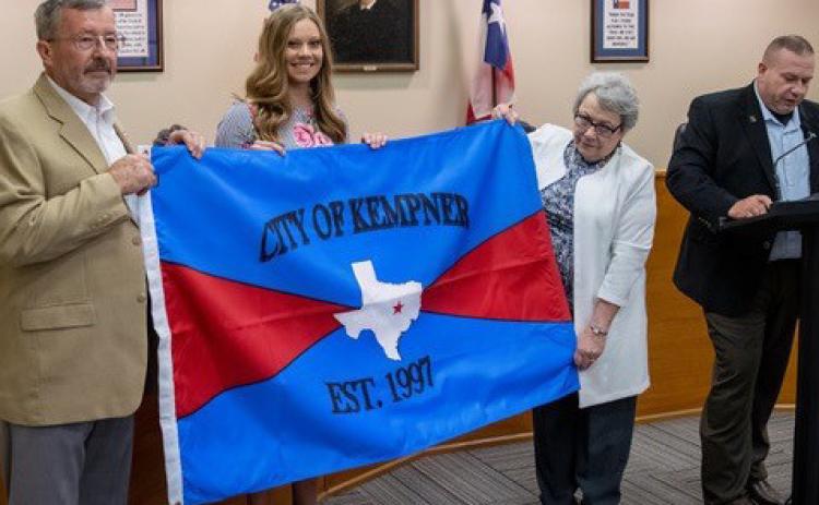 CHRIS MILES | DISPATCH RECORDGene Isenhour, Hayleigh Talasek and former mayor Carolyn Crane hold the new Kempner City Flag as Mayor Wilkerson reads the decree establishing the flag.