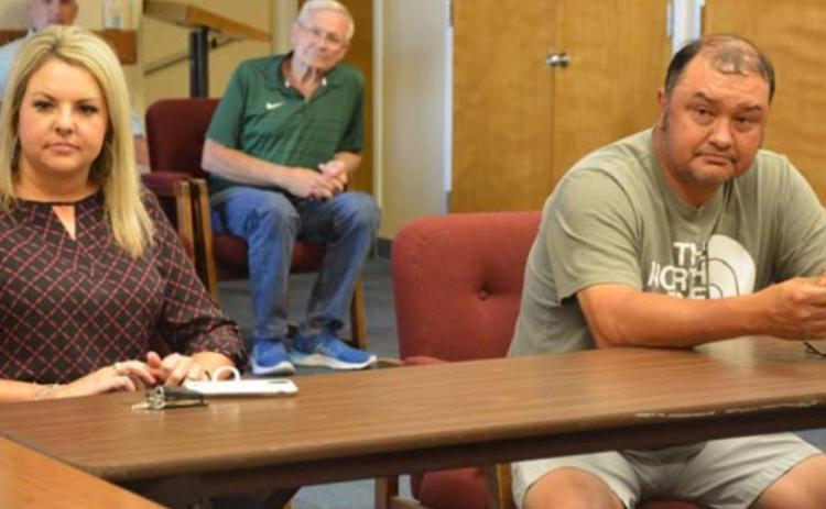 School board candidates Kelsi Davis and Harvey Stinnett listen to school officials explain their choice of action after the May 7 election results ended in a tie. MONIQUE BRAND | DISPATCH RECORD