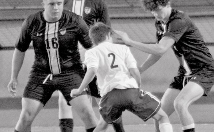 Joseph Whitehead (16), Nate Abken (back-center) and Cody Hinson (far right) defend against Wimberley in a soccer scrimmage at home on Friday. JEFF LOWE | DISPATCH RECORD