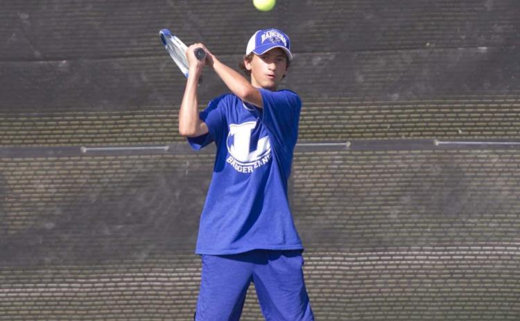 Tyler Ecker hits a backhand shot during a recent match against Ellison before district play begins on Saturday. HUNTER KING | DISPATCH RECORD