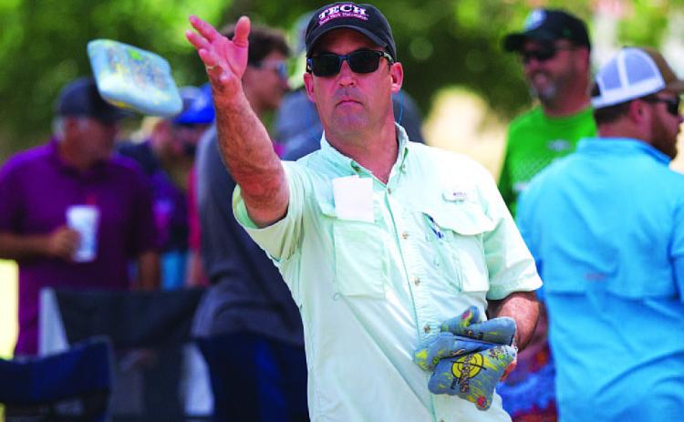 HUNTER KING | DISPATCH RECORD Evan Stubbs tosses a bag early in the cornhole tournament.