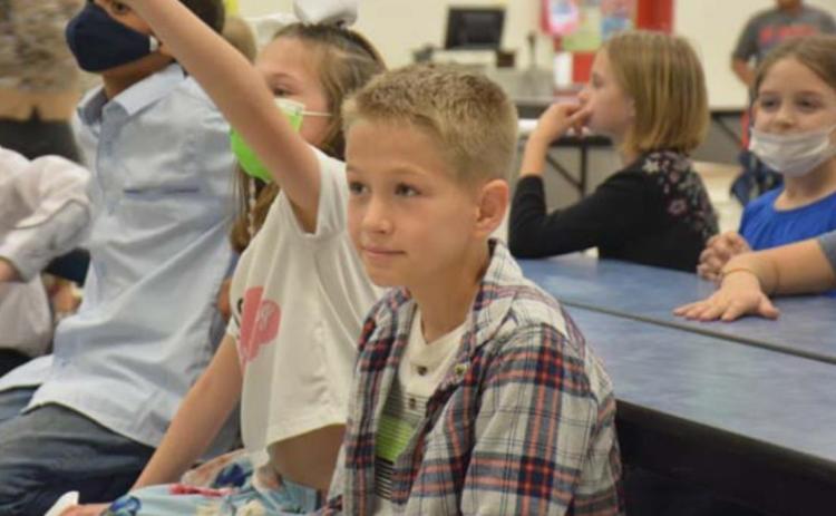 Hunter Ingram, 9, was part of the clean-up crew. He listens to directions given by his third-grade teacher. MONIQUE BRAND | DISPATCH RECORD