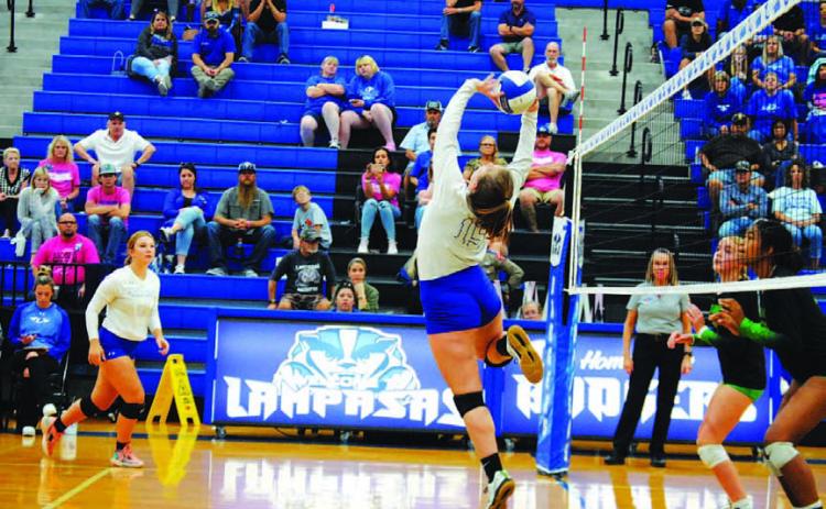 Ava Dowdy flips the ball over the net for a point against Burnet last Friday. HUNTER KING | DISPATCH RECORD