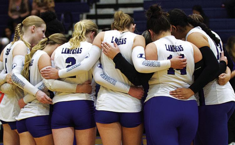 FILE PHOTO The Lady Badger volleyball players huddle up before a game on the road this past season.
