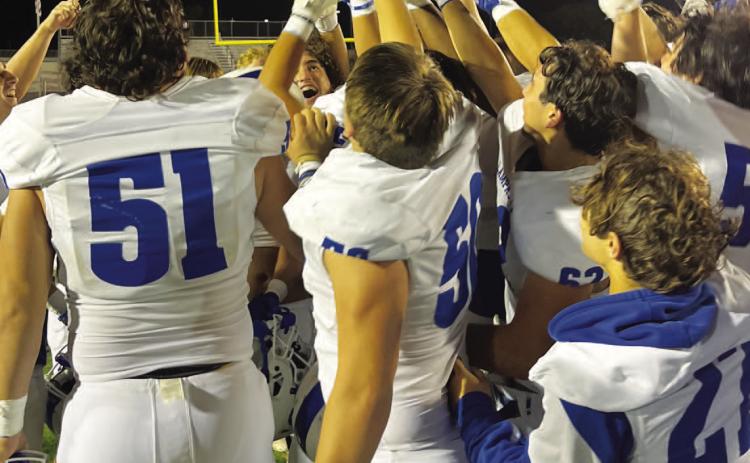 HUNTER KING | DISPATCH RECORD The Badgers hoist the bi-district championship trophy after beating Uvalde last week.