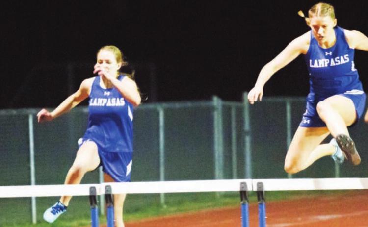 Delanie Smith, right, won the JV girls’ 300-meter hurdles last week at the Johnny “Lam” Jones Relays. Sarah Rouss, left, placed second in this race and won gold in high jump. JEFF LOWE | DISPATCH RECORD