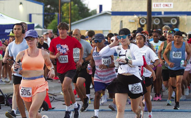 HUNTER KING | DISPATCH RECORD Runners break off for the start of the 10k race at 7 a.m. Saturday morning.