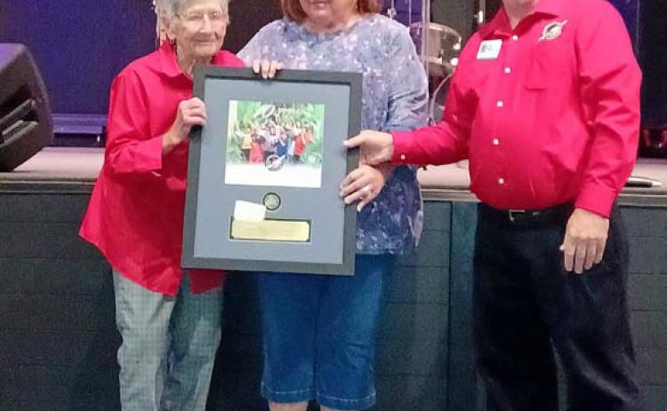COURTESY PHOTO Receiving recognition from Area Coordinator Kirk Bailey of the Mid-TX Area for her 10 years of service as a drop-off leader at Church of the Hills Annex in Lometa is Margaret Williams, at left. She is accompanied by her daughter, Brenda Faubion. Operation Christmas Child is a project of Samaritan’s Purse that collects packed shoebox gifts for delivery to needy children around the world.