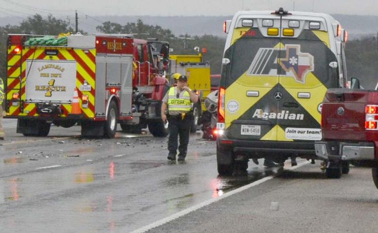 Emergency responders direct traffic around the site of a fatal collision Friday morning on U.S. Highway 190. MADELEINE MILLER | DISPATCH RECORD